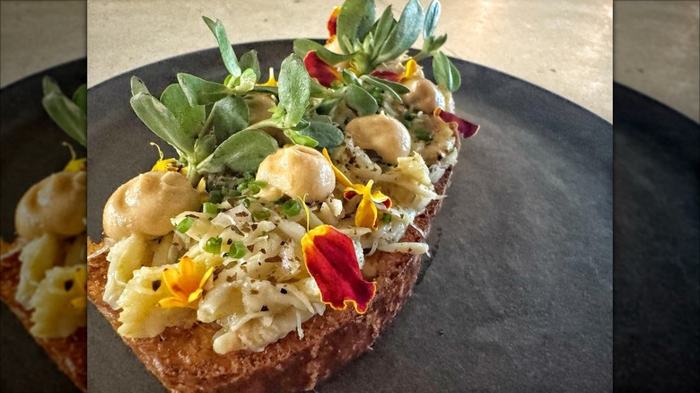 Jonah Crab Tartine with crab, sea urchin, and marigolds