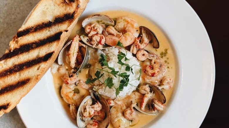 Bourride with shrimp and clams and toasted bread