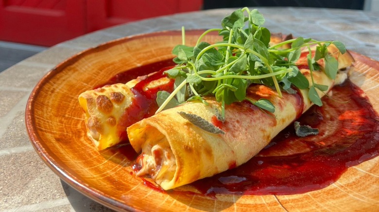Crepes on a plate outside with arugula