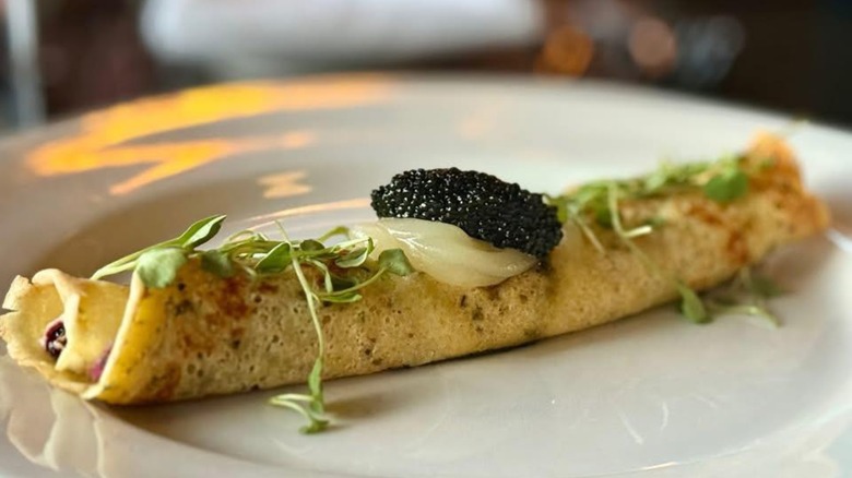 Crepe with caviar on plate