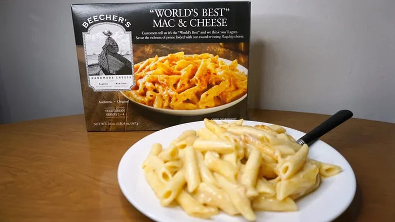 A box of beecher's mac and cheese behind a plate of the prepared mac and cheese