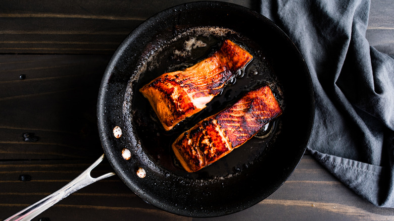 Salmon cooking in a skillet