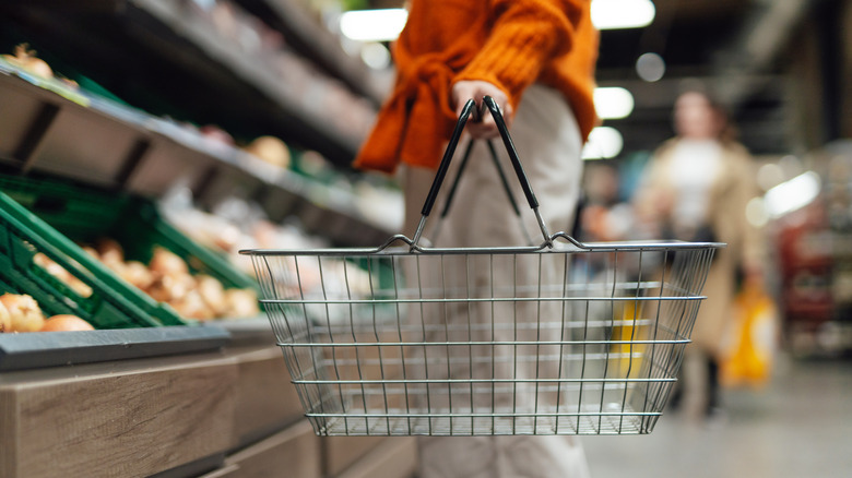 A shopper holding a basket