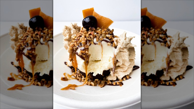 Brownie sundae with various toppings in a white dish