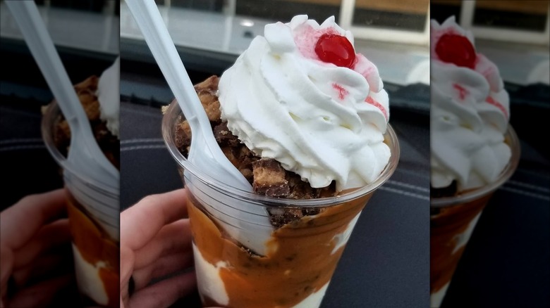 Reese's-themed sundae in a plastic cup with a spoon