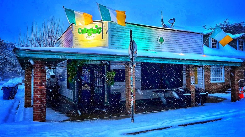 Exterior of Callaghan's on a showy night with Irish flags
