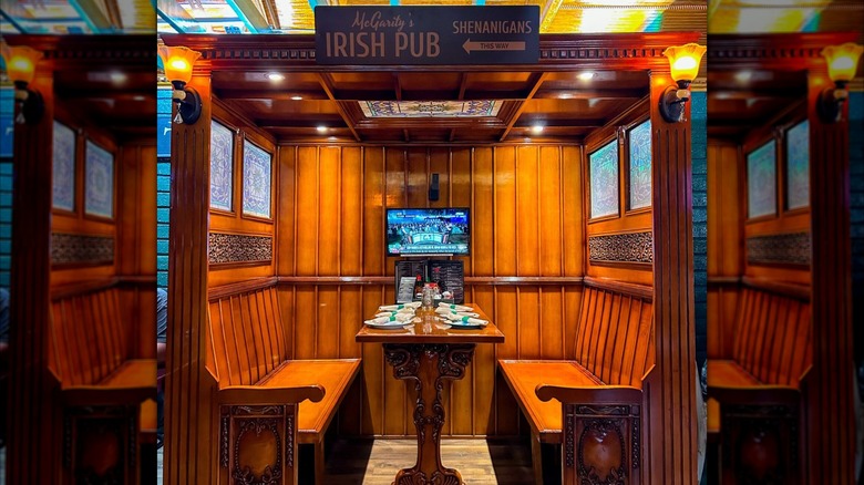 Wood-peneled private booth with table set