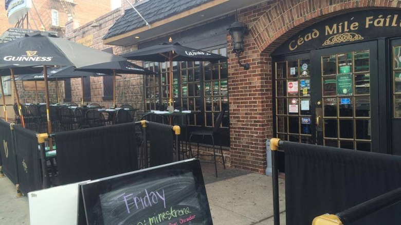 Exterior of Catherine Rooney's with tables and umbrellas on patio