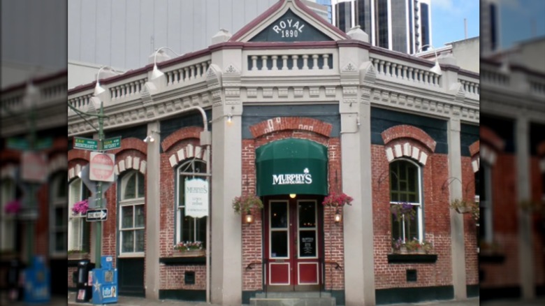Exterior of Murphy's Bar & Grill brick building with green awning