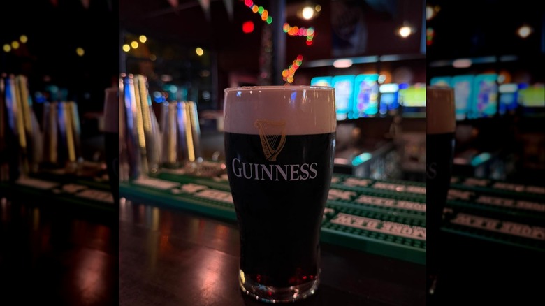 Pint of Guinness on bar with blurred background