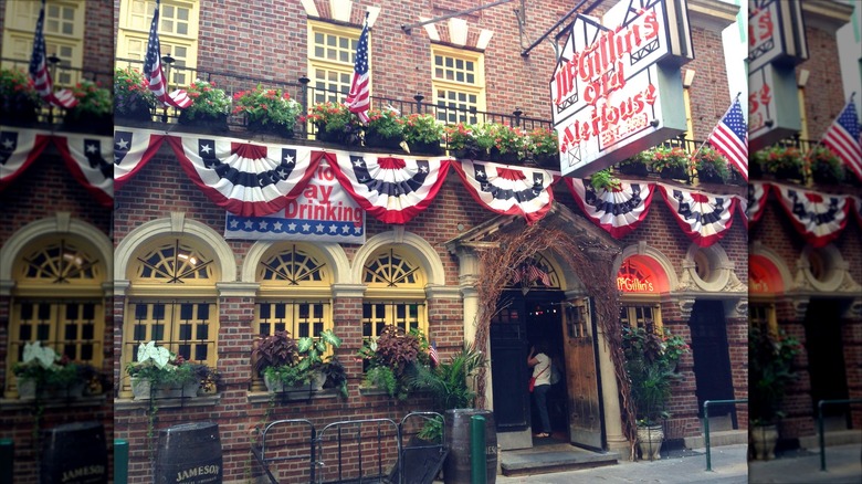 Brick building exterior of McGillin's with flower boxes and flag penants