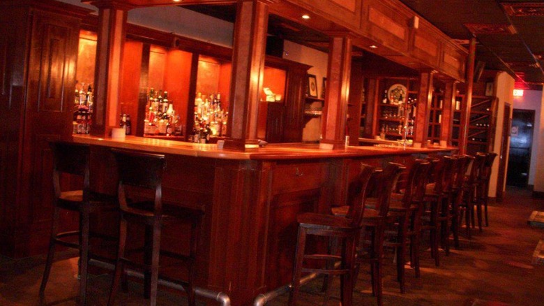 Dimly lit wooden bar with stools