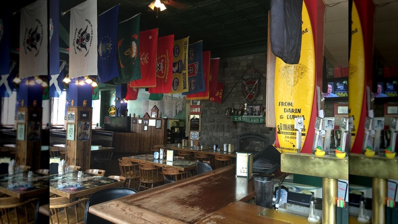Bar with tables and flags hanging from the ceiling