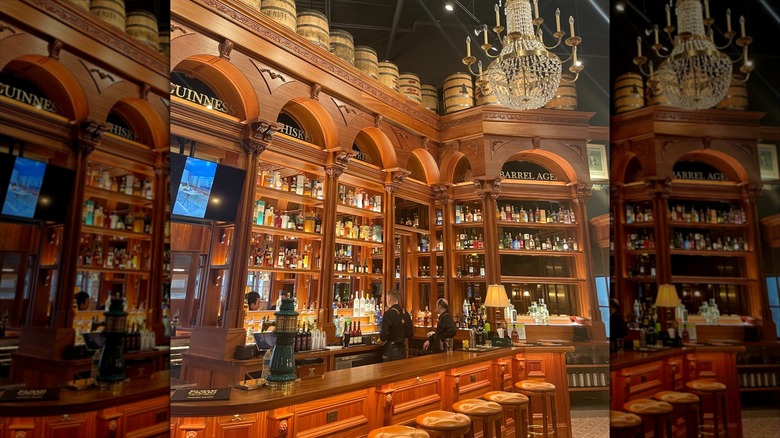 Multi-story bar with barrels on top and empty stools in front