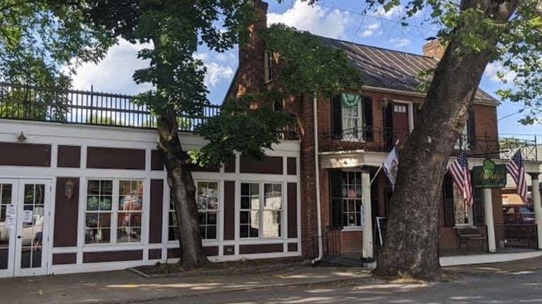 Paddy's exterior 18th century brick building with flags and trees