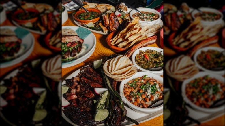 Assortment of Mexican dishes and plates on wooden table