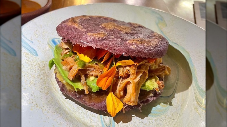 Blue/purple arepas on a decorative plate