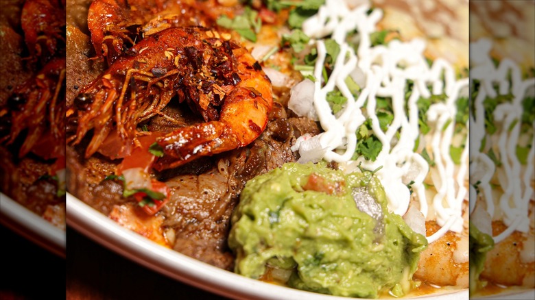 Close-up on plate with guac, crema, and crayfish