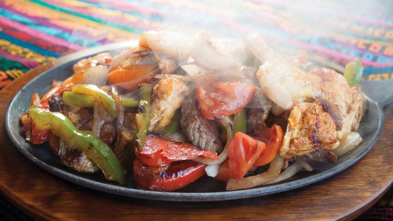 Chicken fajitas steaming on a plate
