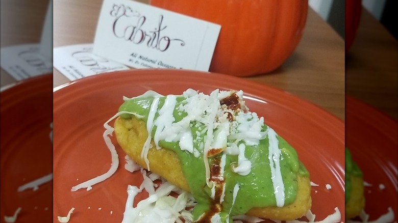 Molotes de papa con chorizo with sauces on plate