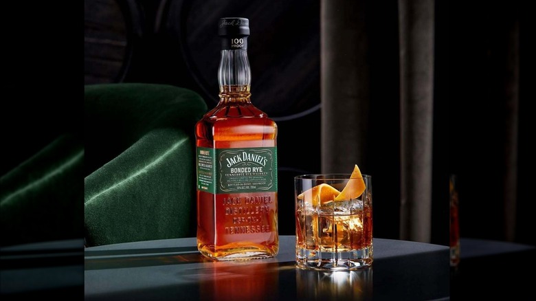 Bottle of Jack Daniel's rye with a cocktail on the side
