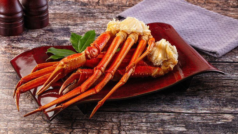 steamed crab legs sit on a plate
