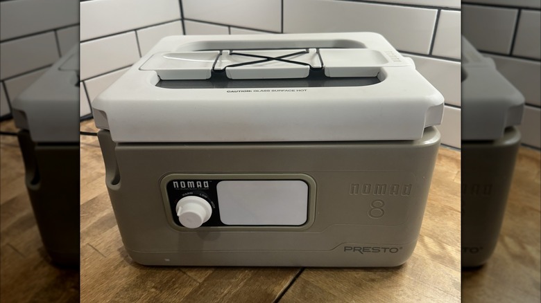 A gray Presto Nomad slow cooker on a counter