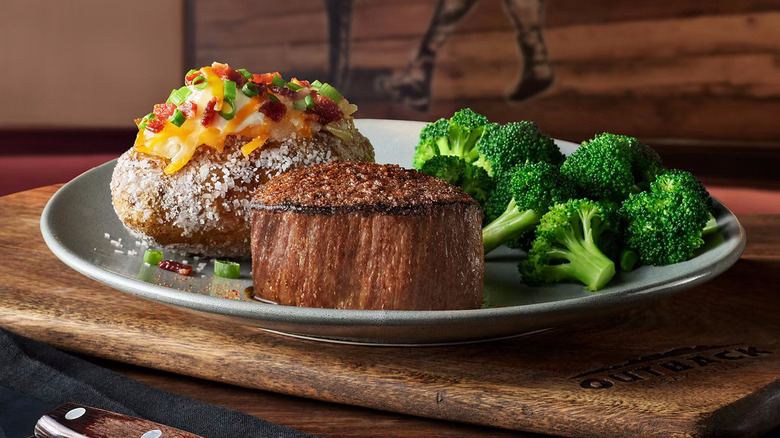 Victoria's filet mignon on white plate with two sides from Outback Steakhouse
