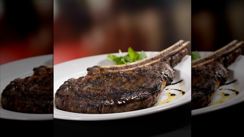 The Capital Grille's bone-in ribeye steak on white plate