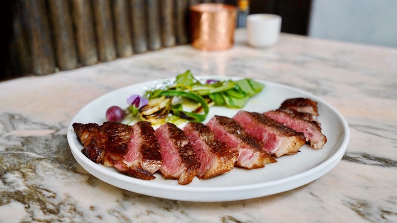 Wagyu steak sliced on a place on marble tabletop