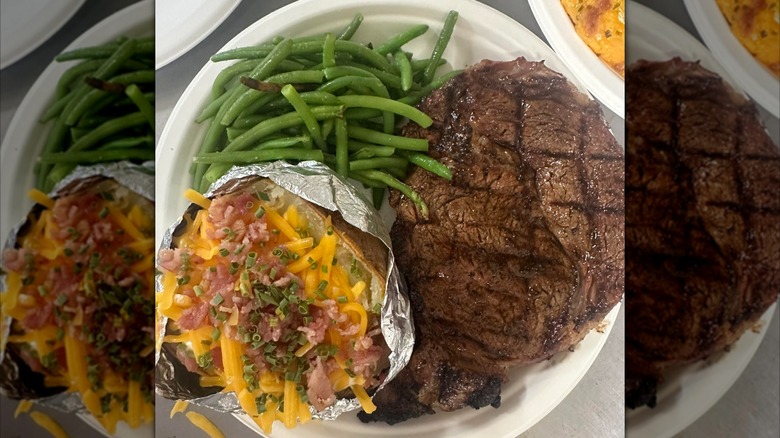 Steak on a plate with loaded baked potato and green beans