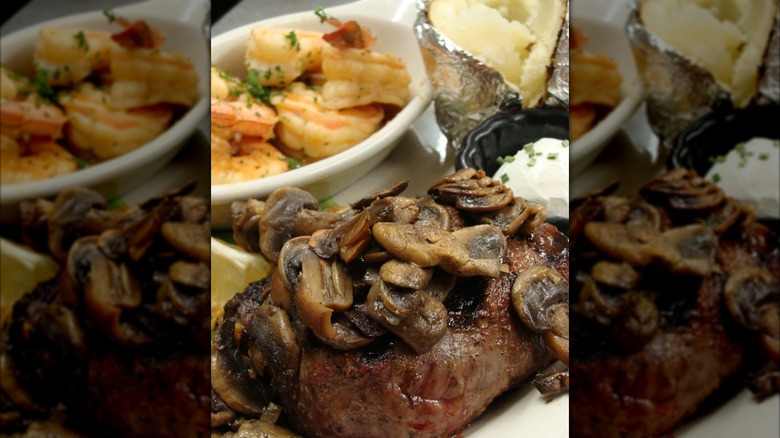 Steak with mushrooms, bowl of shrimp and baked potato