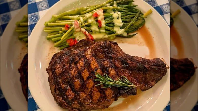 Steak with asparagus and sauce drizzle on plate