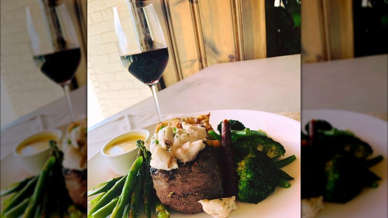 Filet with mashed potatoes, asparagus, and broccoli and glass of wine