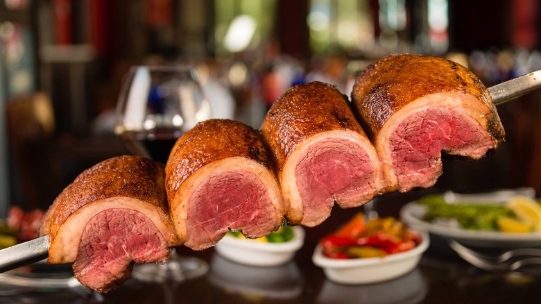 Texas De Brazil's top sirloin skewer over blurred background