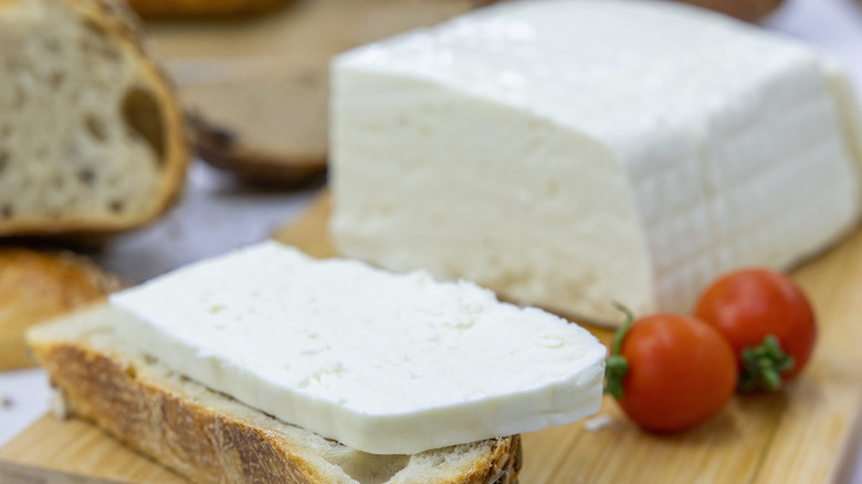 block of cream cheese with grape tomatoes and toast