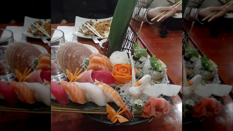 Nigiri, sashimi, and uramaki rolls on a decorative platter