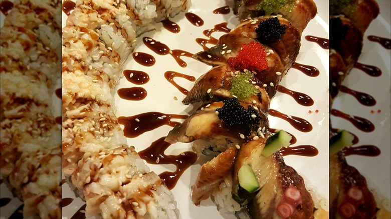 Uramaki topped with unagi, soy glaze, and caviar