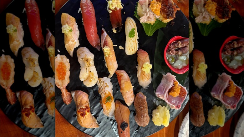 Assorted nigiri platter on a black plate