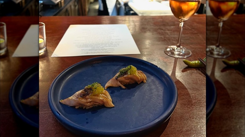2 pieces of nigiri on a blue plate