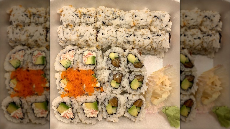 Salmon uramaki rolls topped with caviar