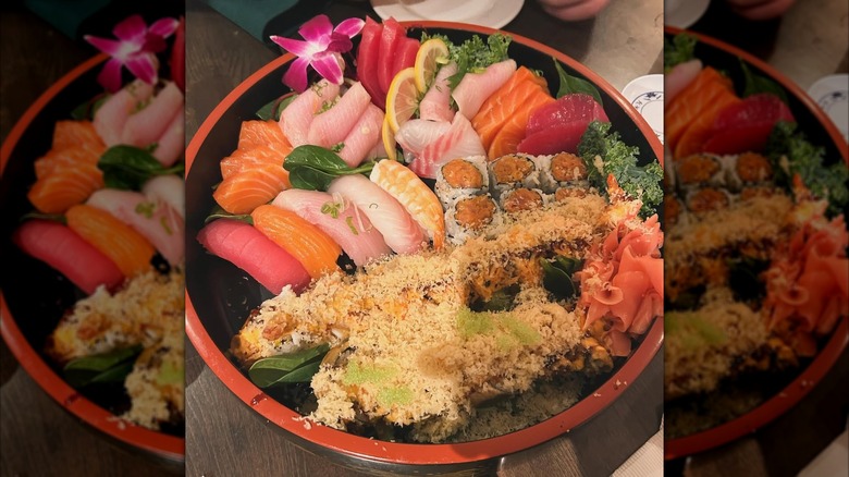 Assorted sushi platter of nigiri, uramaki, sashimi, and tempura topped rolls