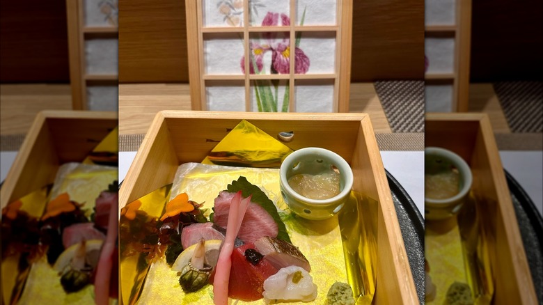 Wooden box containing sashimi