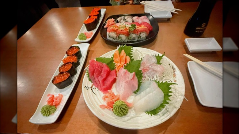 Caviar rolls, uramaki rolls, and sashimi platter