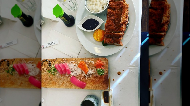 Wooden culinary board with assorted sashimi