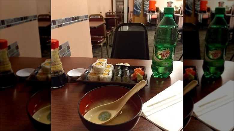 Sushi and uramaki rolls and bowl of miso soup