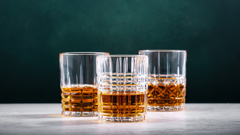 Glasses of neat whiskey on a marble surface