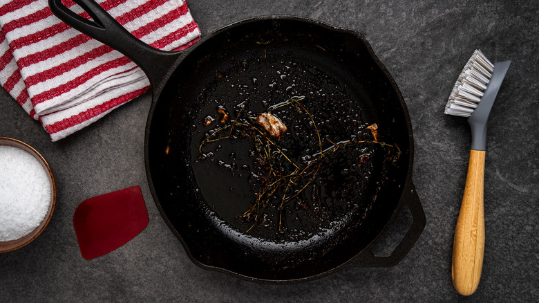 used cast iron skillet with cleaning brush