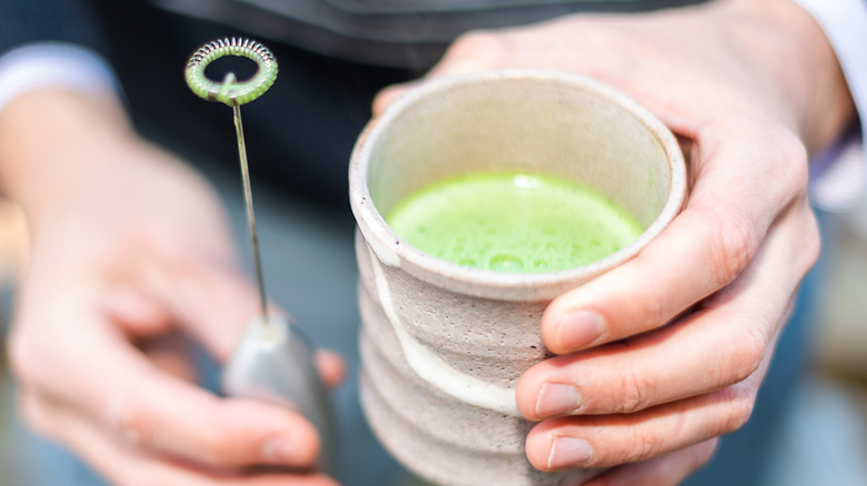 Mixing matcha with a milk frother