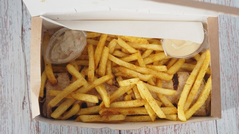 French fries in a box with dipping sauce